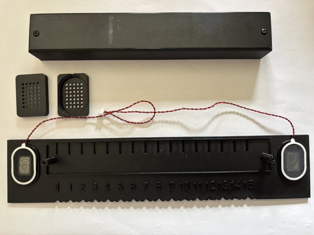 Plastic components of talking ruler together with speakers.